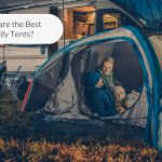 Picture of a tent with a family inside beside a campervan