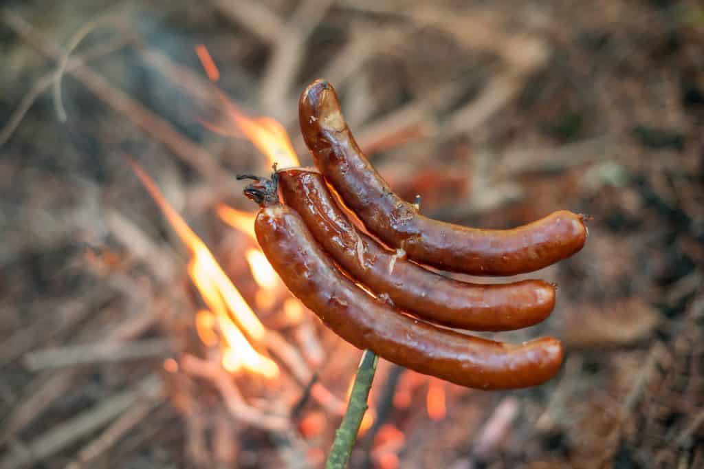 Photo of sausage roasted on camp fire