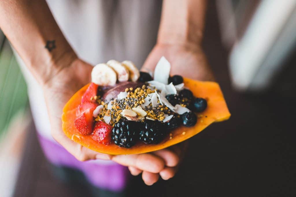 Photo of Delicious mixture of fruits dessert on someone's hand