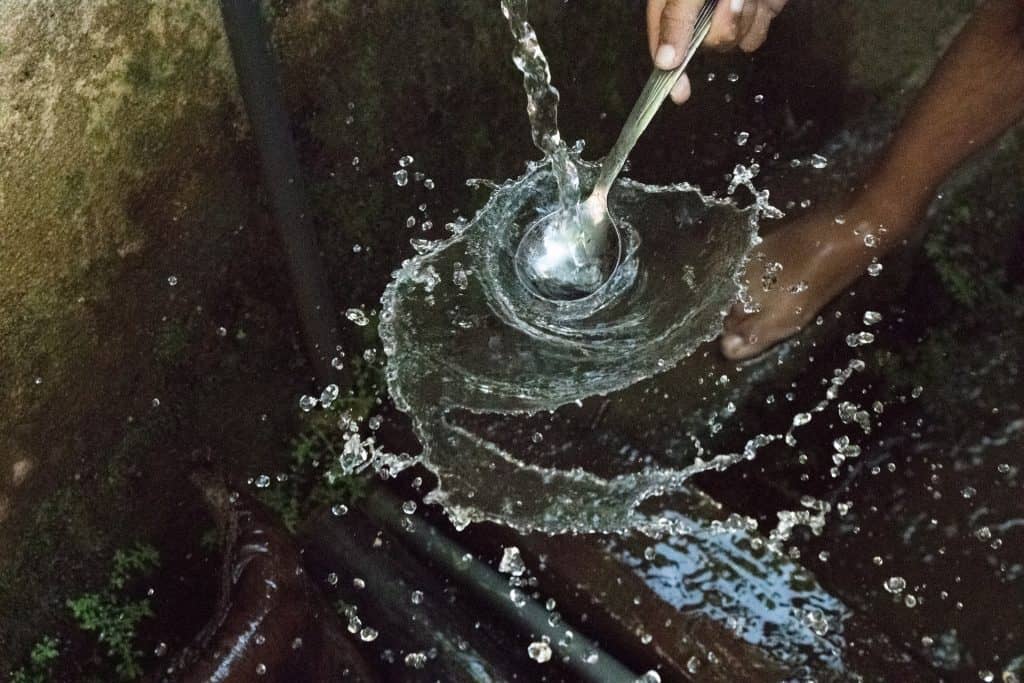 Someone pouring water using a water hose